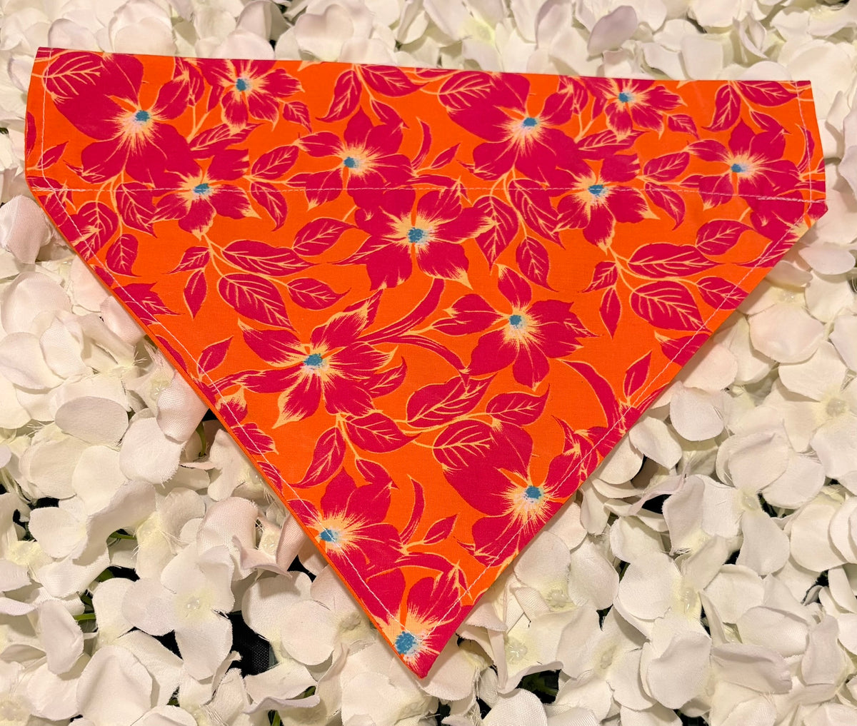 Orange tropical flower print dog bandana with crimson blooms